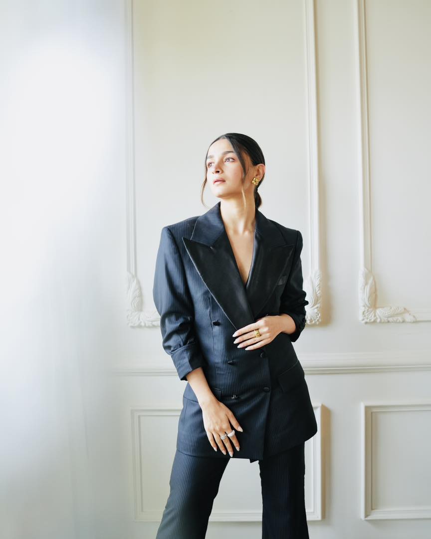 Alia Bhatt wearing a stylish black blazer suit standing in a bright elegant room – Bollywood actress HD wallpaper