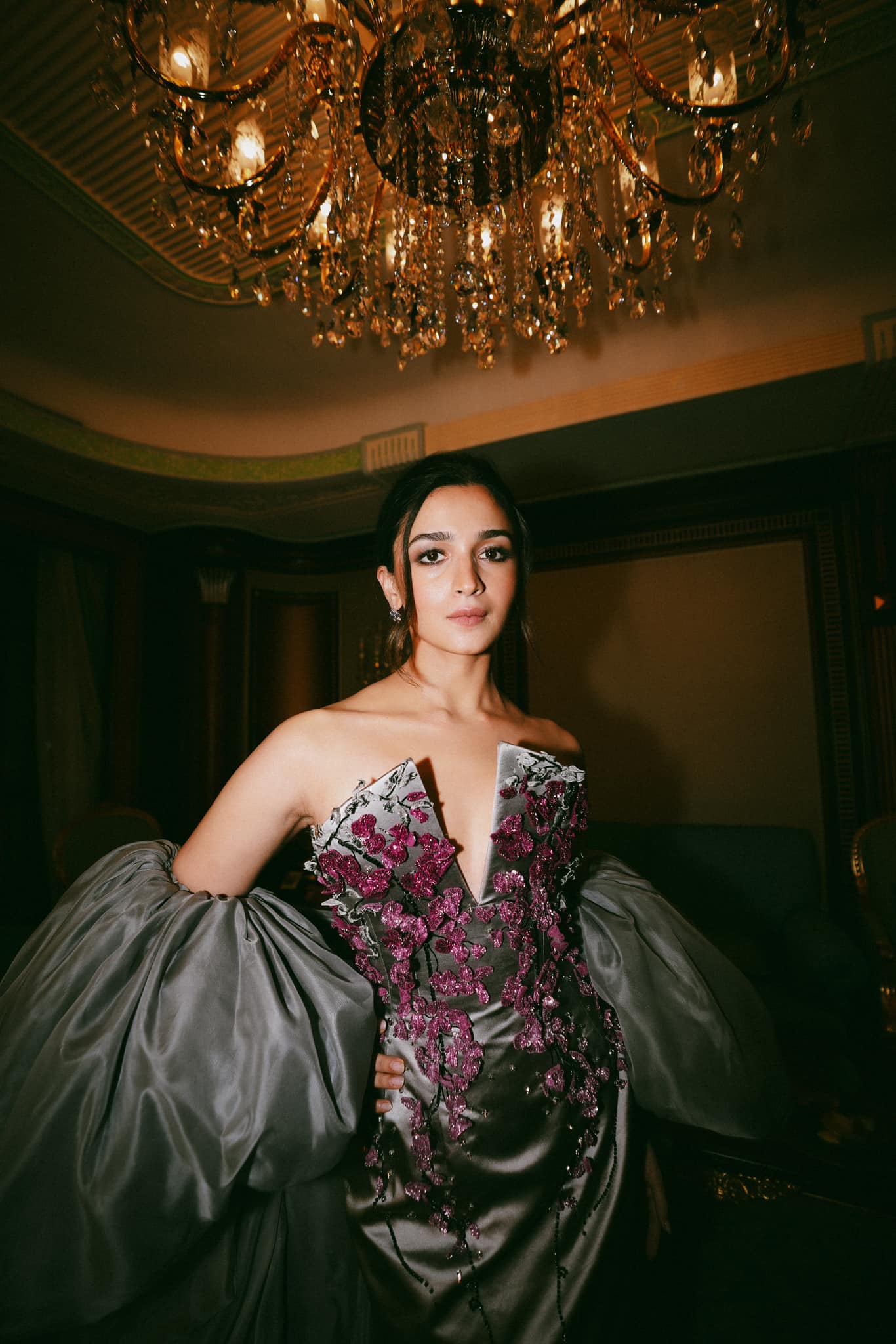 Alia Bhatt wearing an elegant designer gown under a crystal chandelier in a royal indoor setting – Bollywood actress HD wallpaper