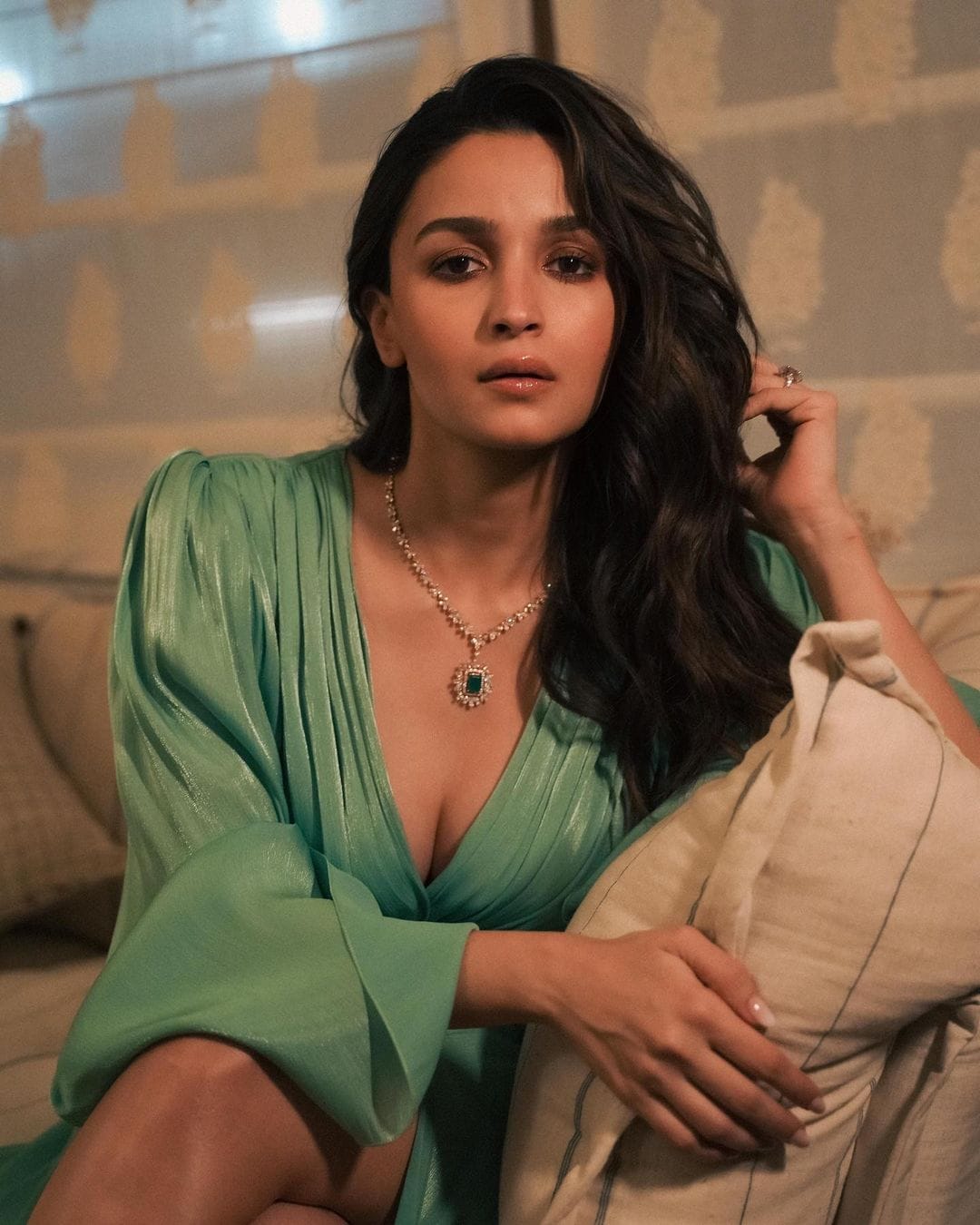 Alia Bhatt wearing an elegant green dress with diamond necklace sitting on a sofa during a glamorous photoshoot – Bollywood actress HD wallpaper