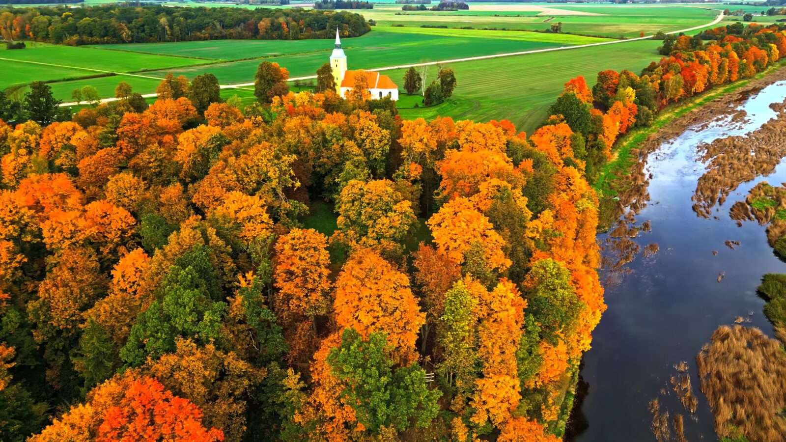 Autumn scene with church in rural area, where the trees are full of golden leaves, Wonders of the World Pictures.
