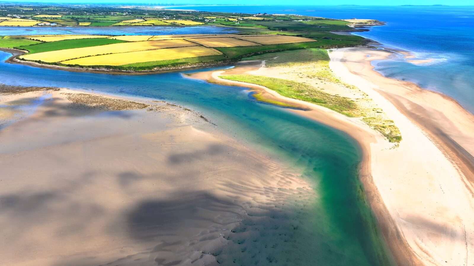 Beautiful view of the river and beach, showing blue water and golden sand, Wonders of the World Pictures.
