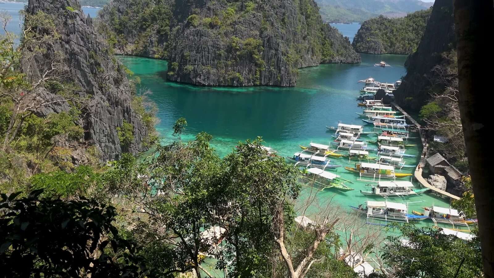 Boats tied up in the water near the mountains are a symbol of peace and natural beauty, Wonders of the World Pictures.
