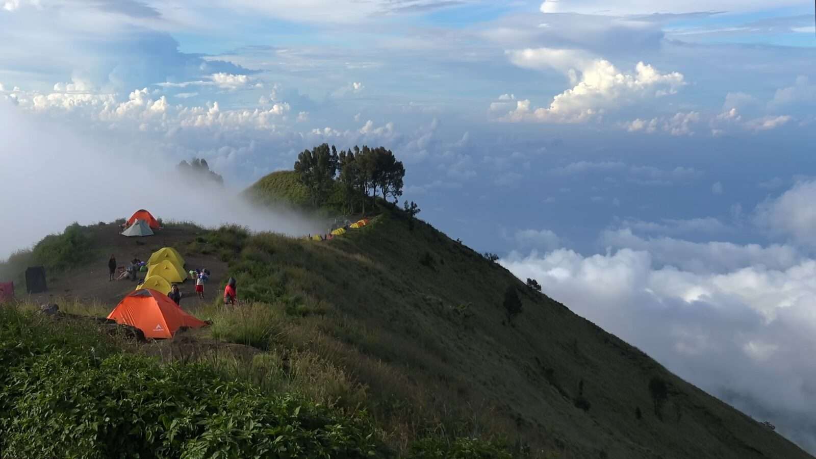 A cluster of tents high up on a mountain, offering a camping and adventure experience, Wonders of the World Pictures.
