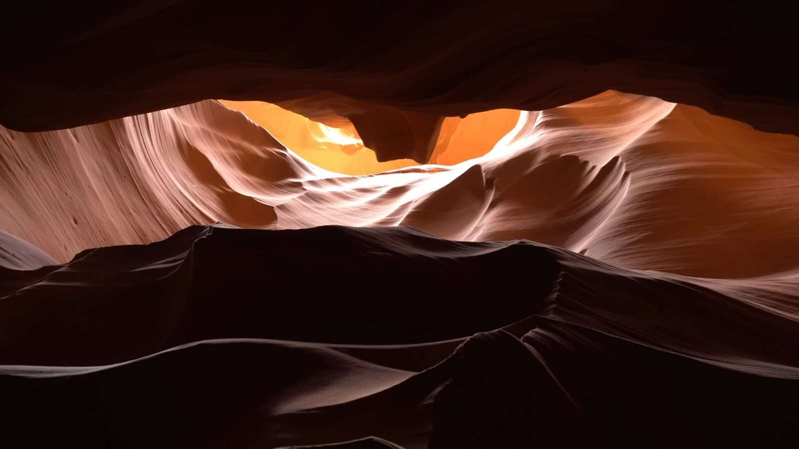 At Antelope Canyon, rays of light radiate through the canyon, creating a breathtaking sight, Wonders of the World Pictures.
