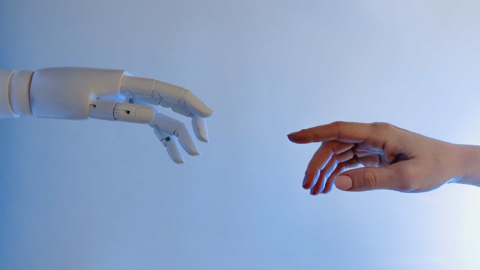 Robot and Man Hand 4K Picture with Light Blue Background Picture.