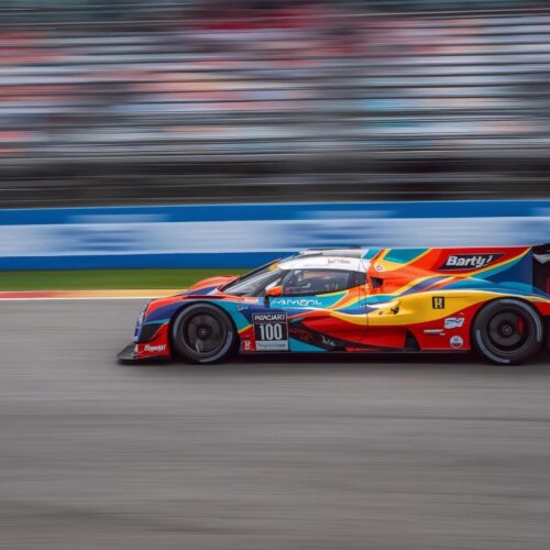 Colorful racing car in motion on a professional race track – dynamic 4K Cool Wallpaper