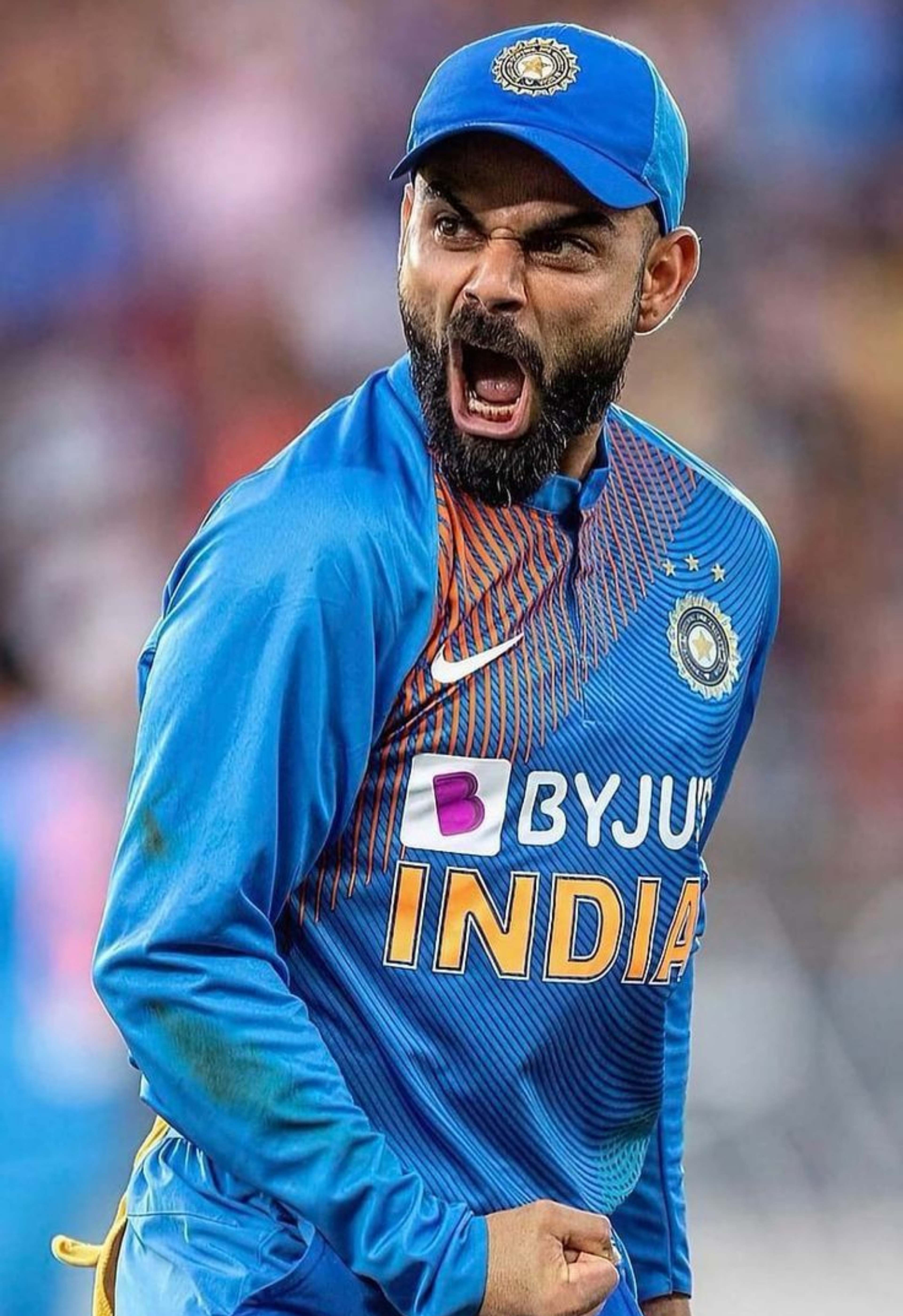 Virat Kohli showing an aggressive celebration in India cricket jersey – 4K close-up wallpaper