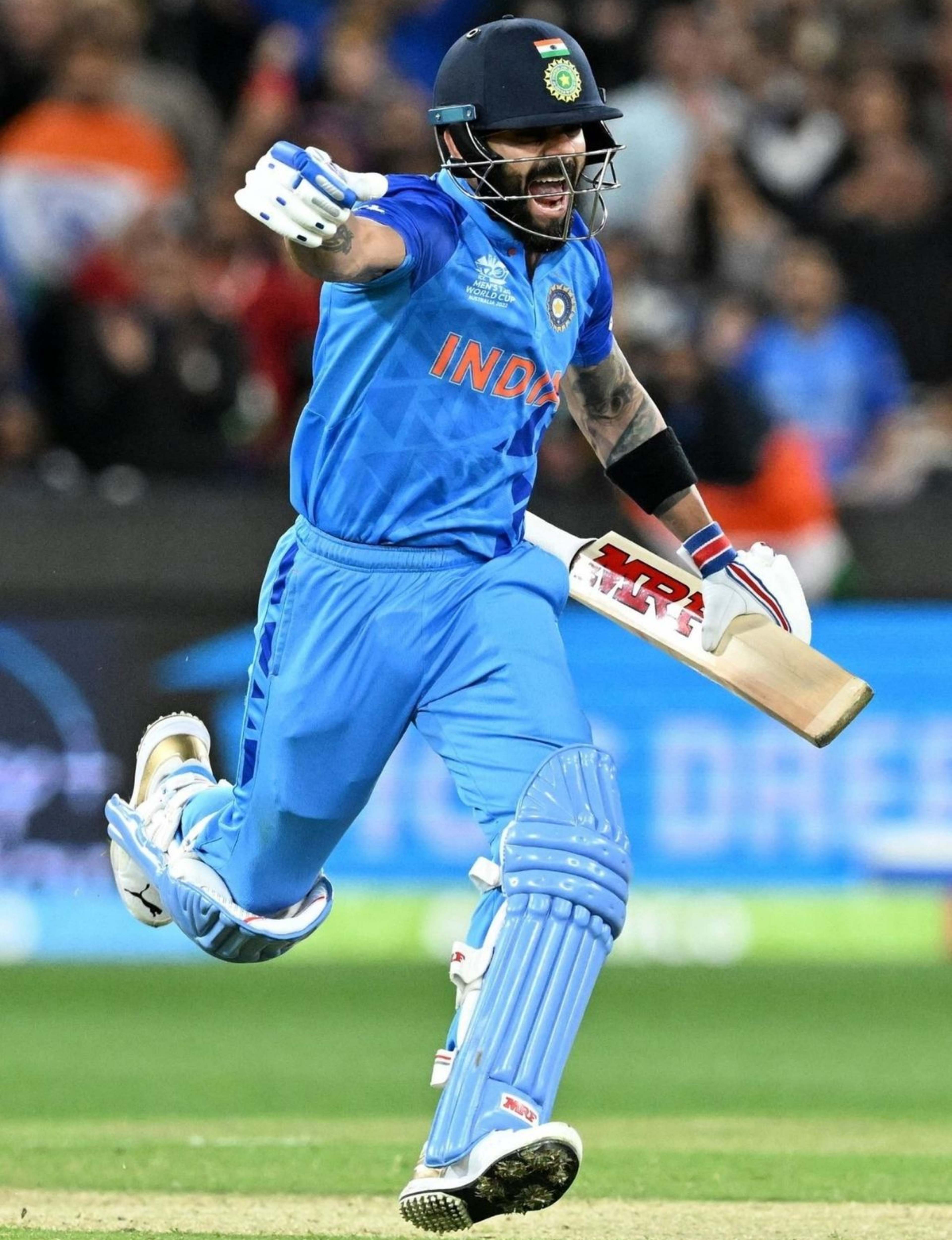 Virat Kohli celebrating a winning moment in India cricket jersey during a match – 4K action wallpaper