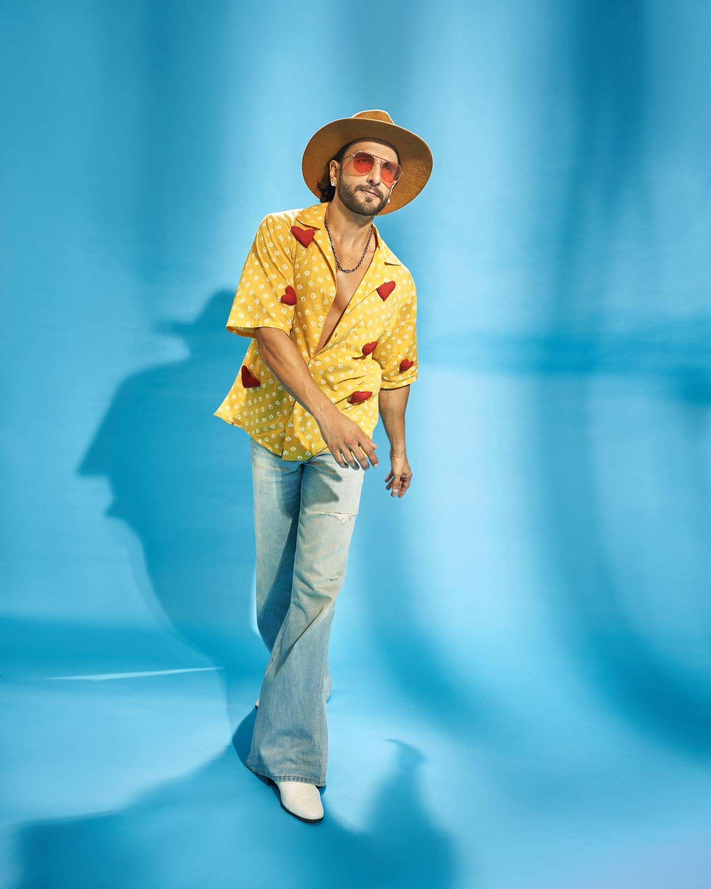 Ranveer Singh one of Bollywood’s dynamic and versatile actors 3 Ranveer Singh in bright yellow outfit posing on blue background 4k pictures