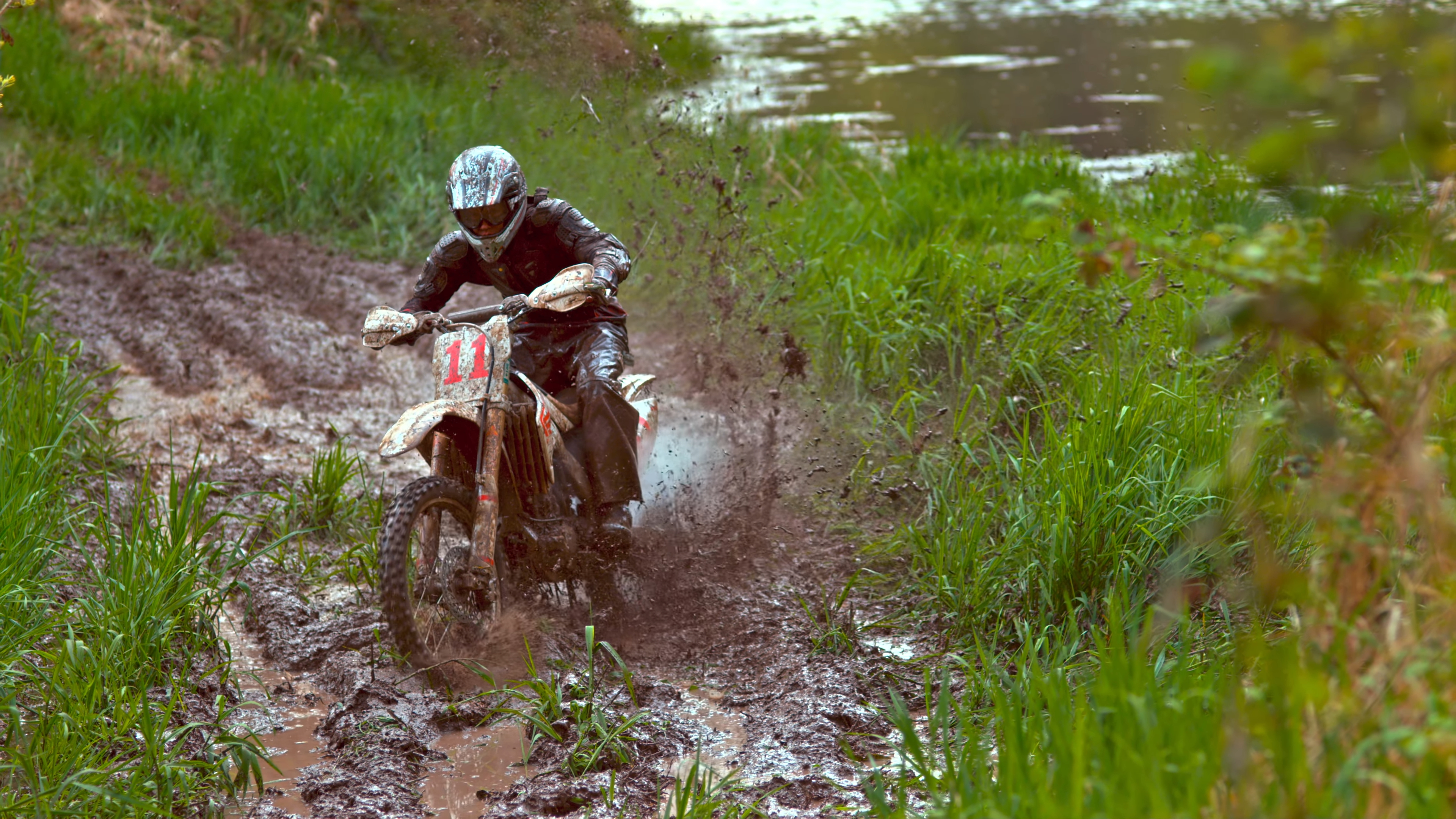 Color Wallpaper 4K dirt bike riding in mud action scene