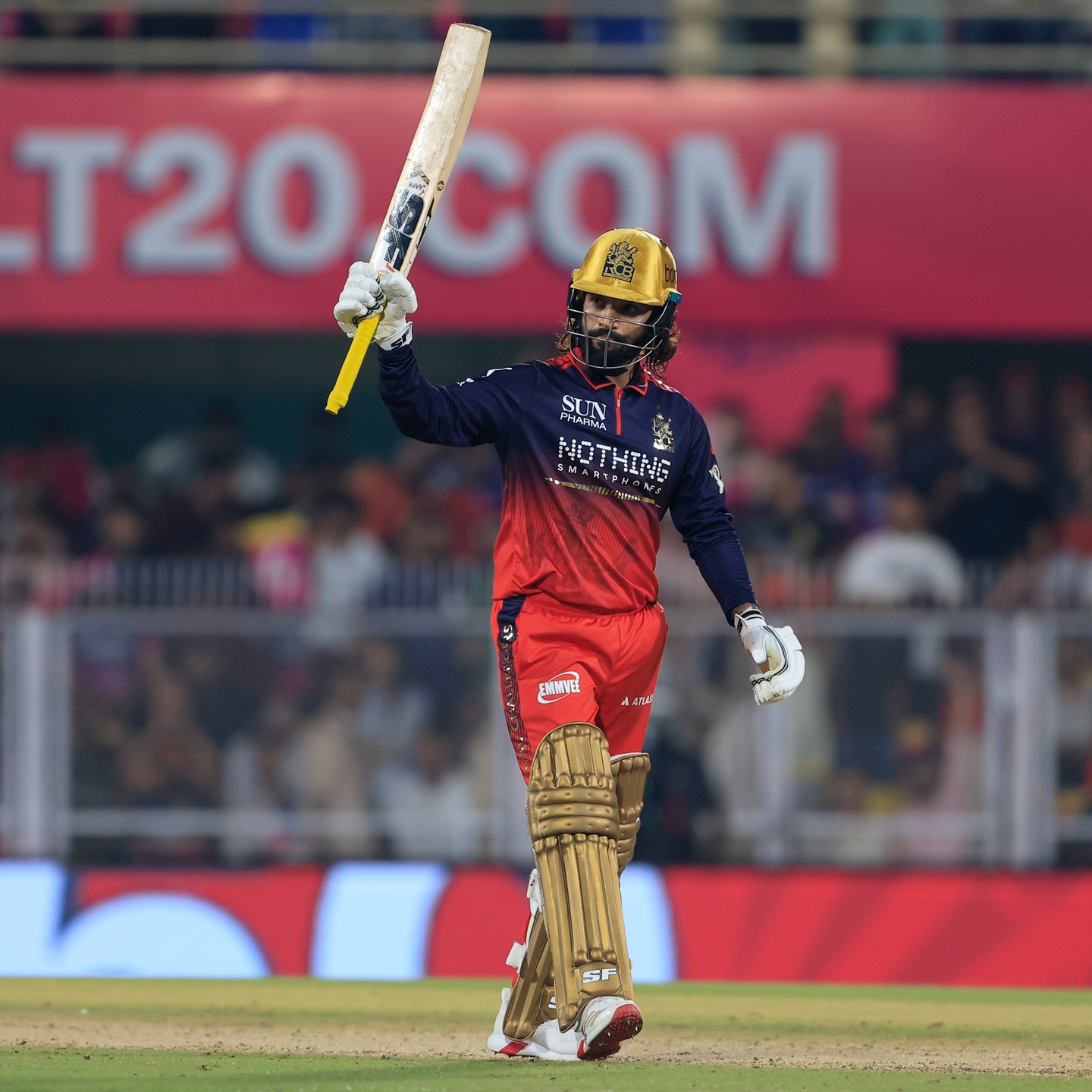 Rajat Patidar raising bat after scoring runs in IPL match