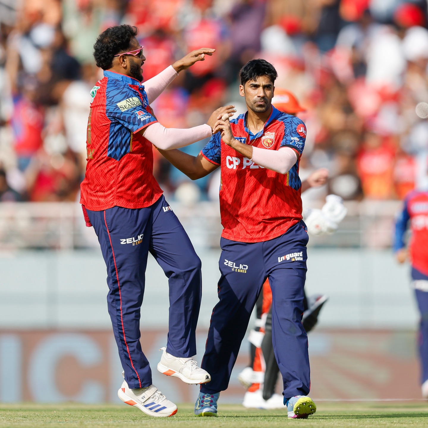 Shashank Singh bowling during IPL match with teammate celebrating