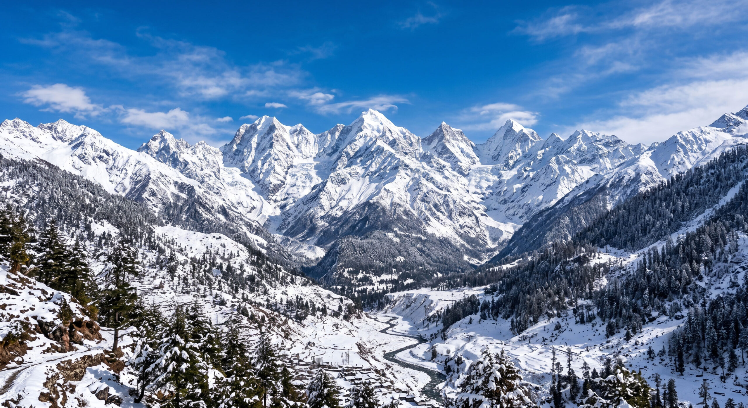 Snow-covered mountain peaks under a beautiful blue sky.